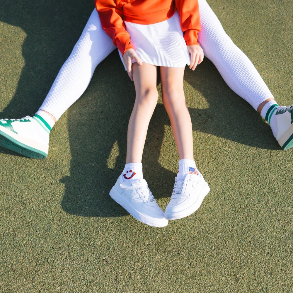 Del Campo Kids Pack golf socks featuring four kids' designs: smiley, blue smiley, pink smiley, and 1776