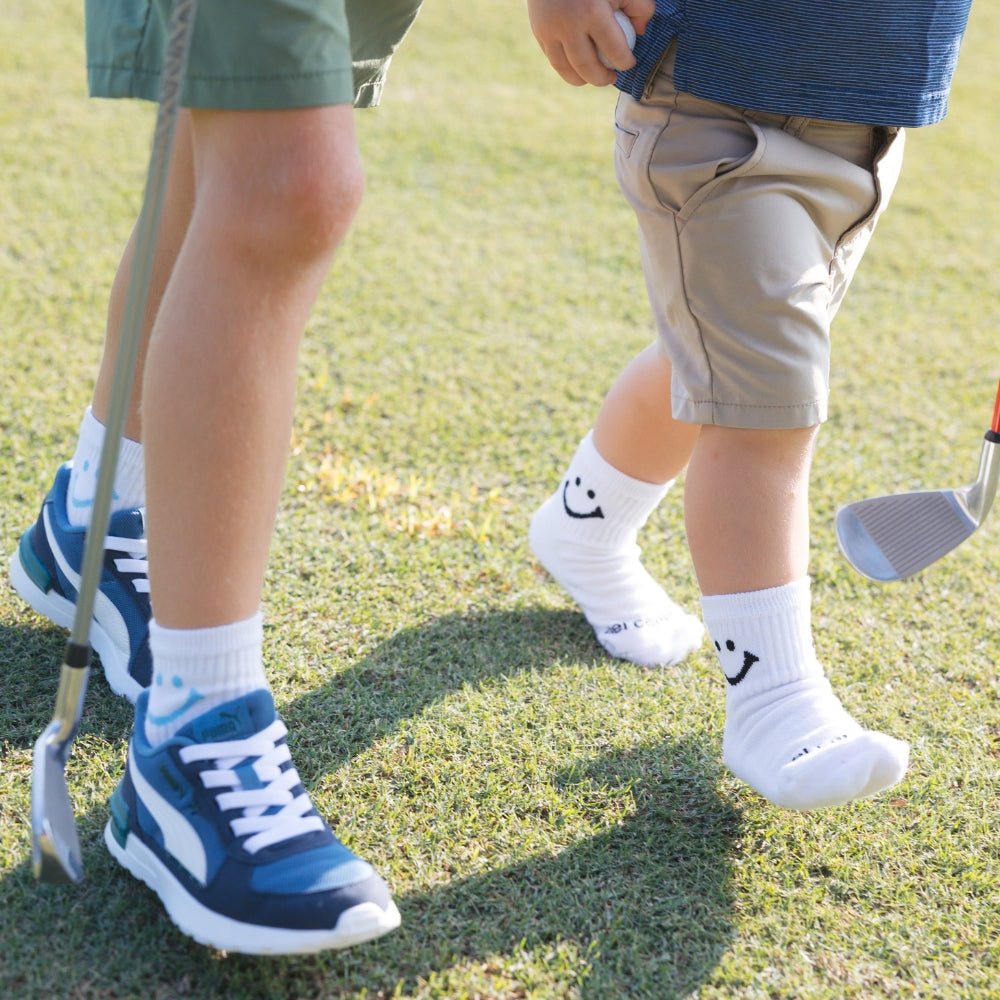 Del Campo Kids Pack golf socks featuring four kids' designs: smiley, blue smiley, pink smiley, and 1776