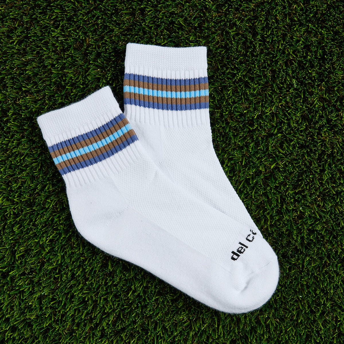 Del Campo Denim 5 Stripe golf socks, flat lay on grass