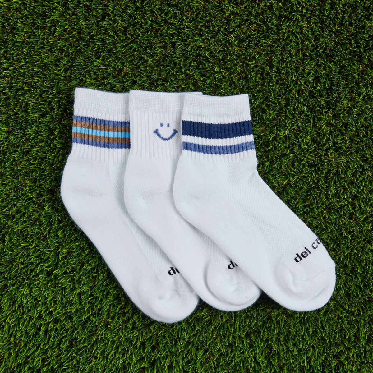 Del Campo Fall Denim Pack golf socks, pack flat lay on grass