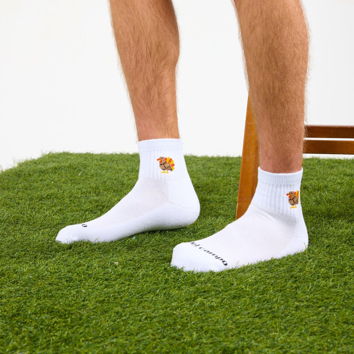 Del Campo Turkey Boys Thanksgiving golf socks, white quarter socks with a knit turkey, worn on the grass