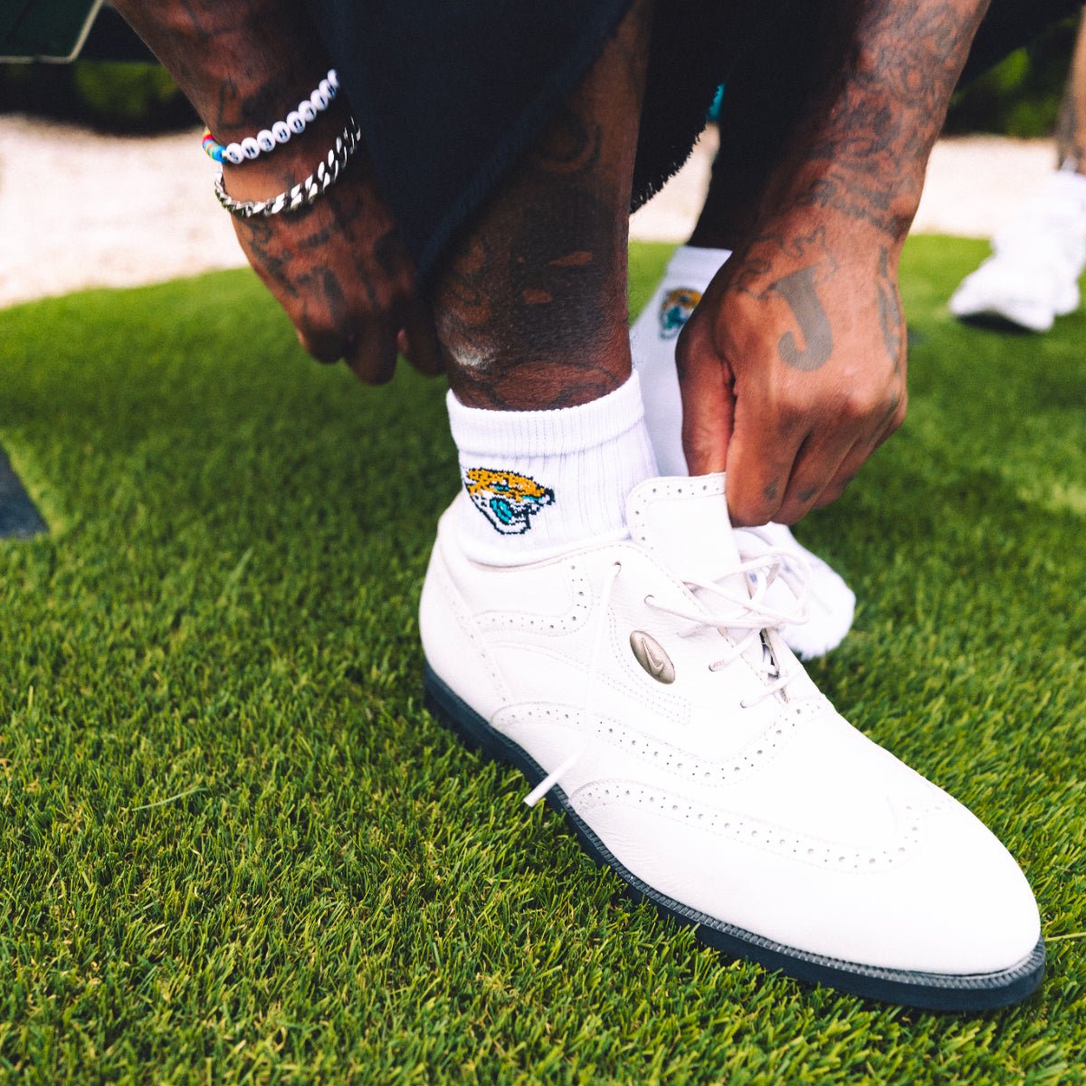Jacksonville Jaguars quarter sock by Del Campo, white with an embroidered Jaguars head