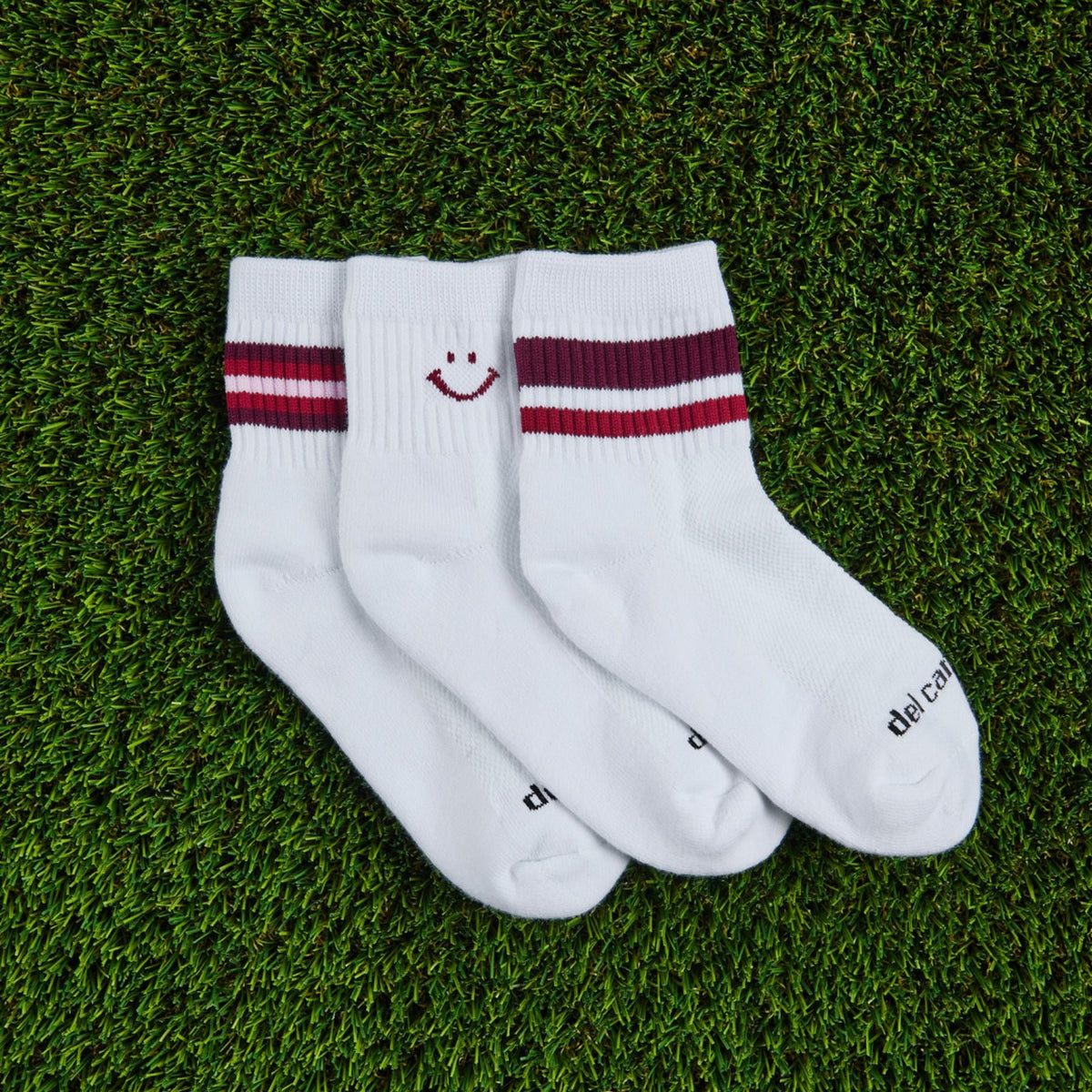 Del Campo Fall Cardinal Pack golf socks, pack flat lay on grass