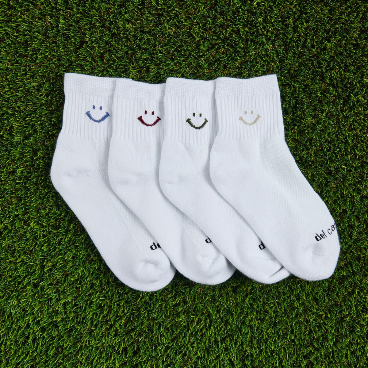 Del Campo Fall Smiley Pack golf socks, pack flat lay on grass