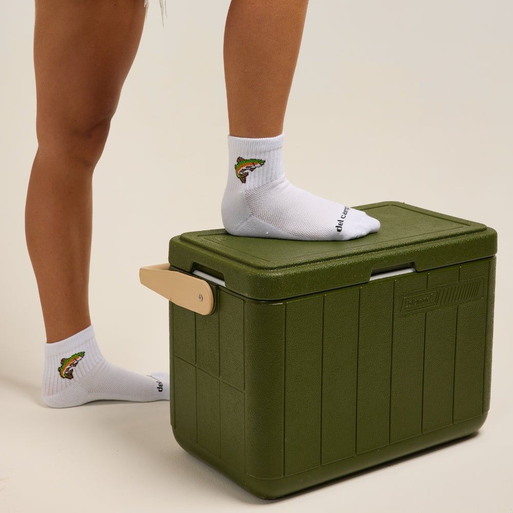 Del Campo Kids Trout socks worn while standing on a green cooler