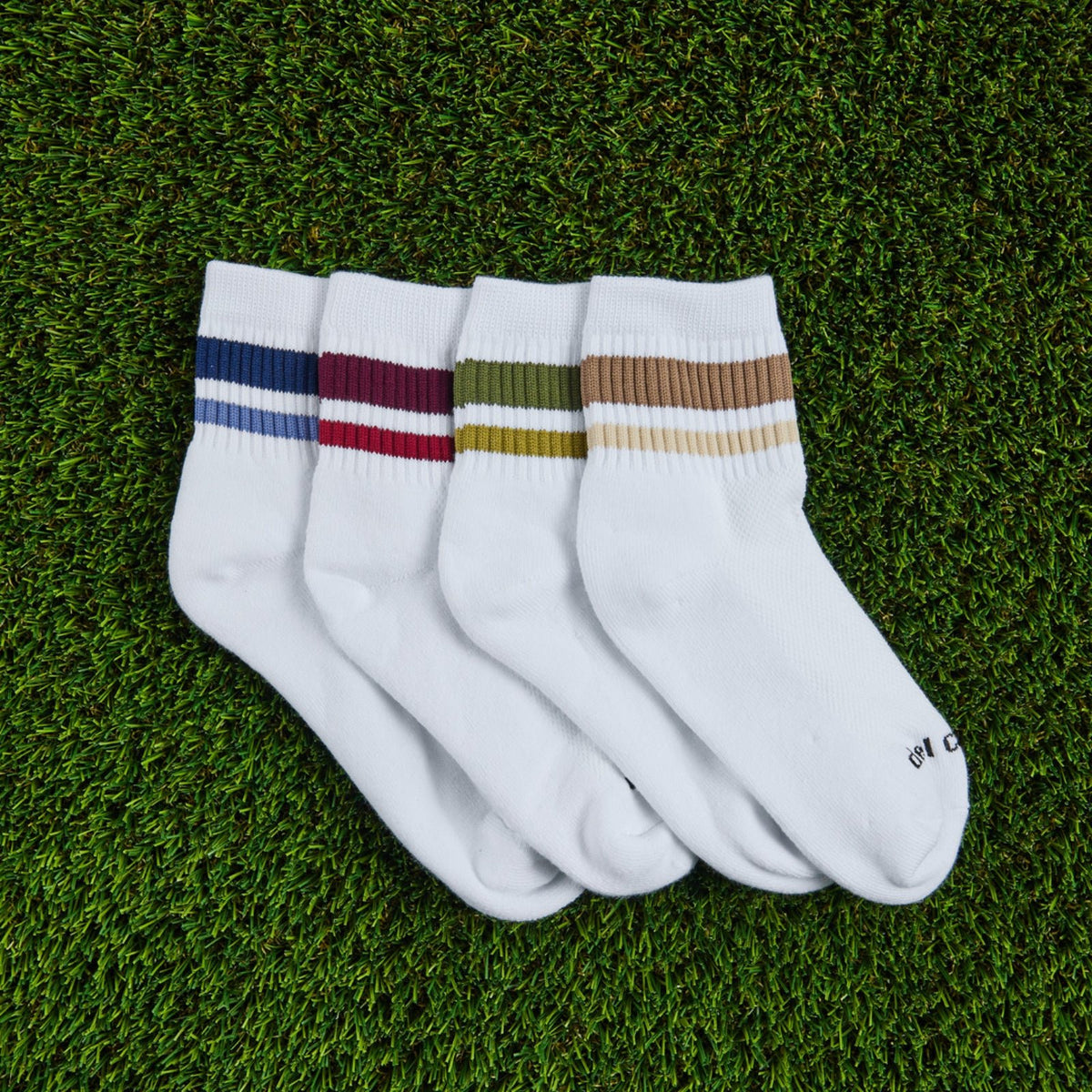 Del Campo Fall Stripe Pack golf socks, pack flat lay on grass