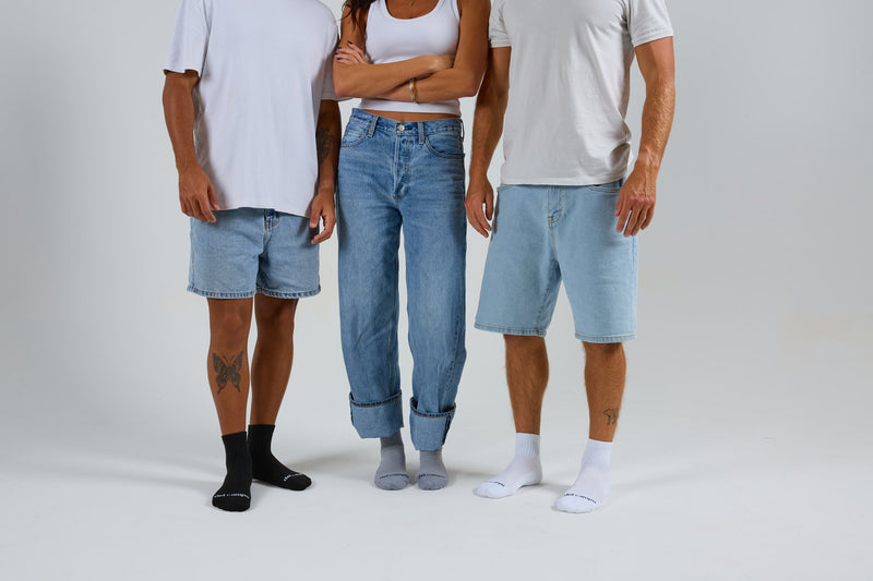 Three people in black, grey and white Del Campo blank socks