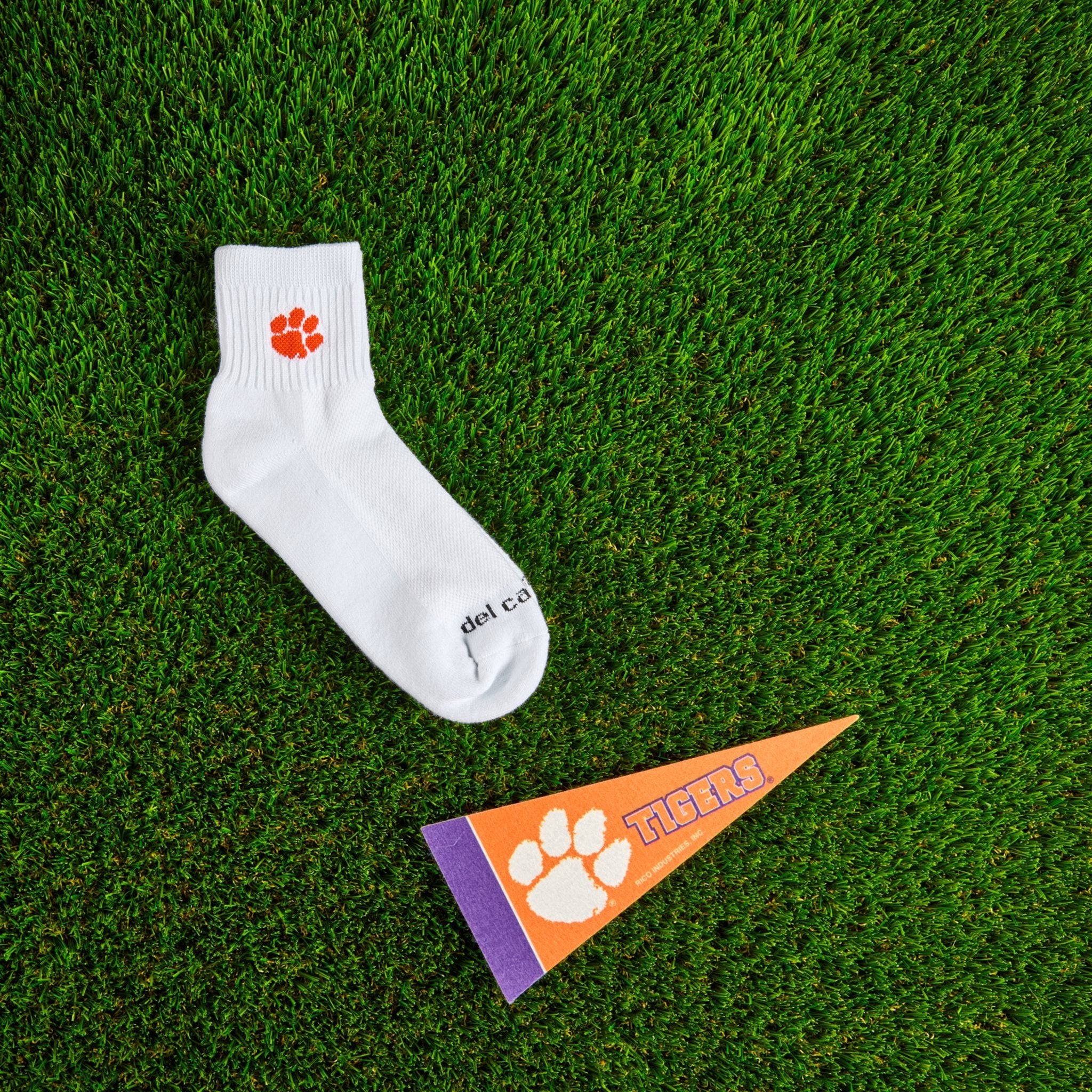 Flat lay of Del Campo Clemson Tigers golf socks with game-day props