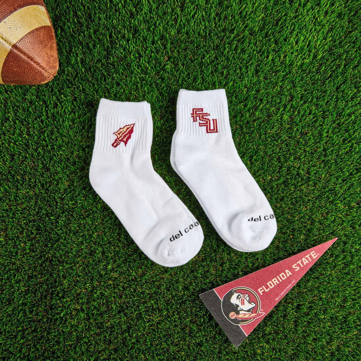 Del Campo Florida State Pack golf socks on turf with a team pennant