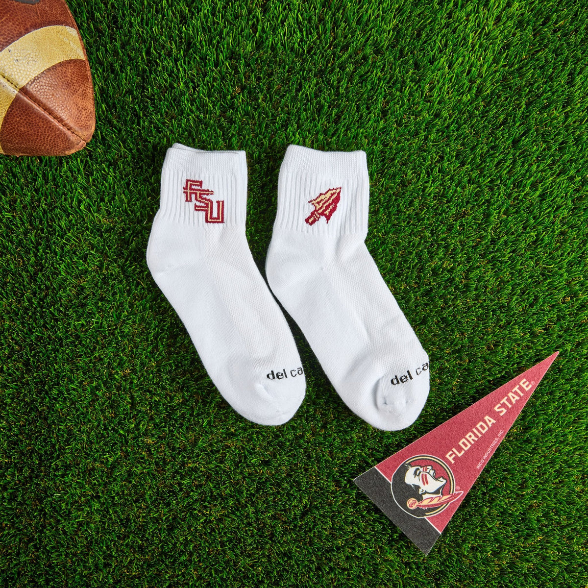 Flat lay of Del Campo Florida State Pack golf socks with game-day props