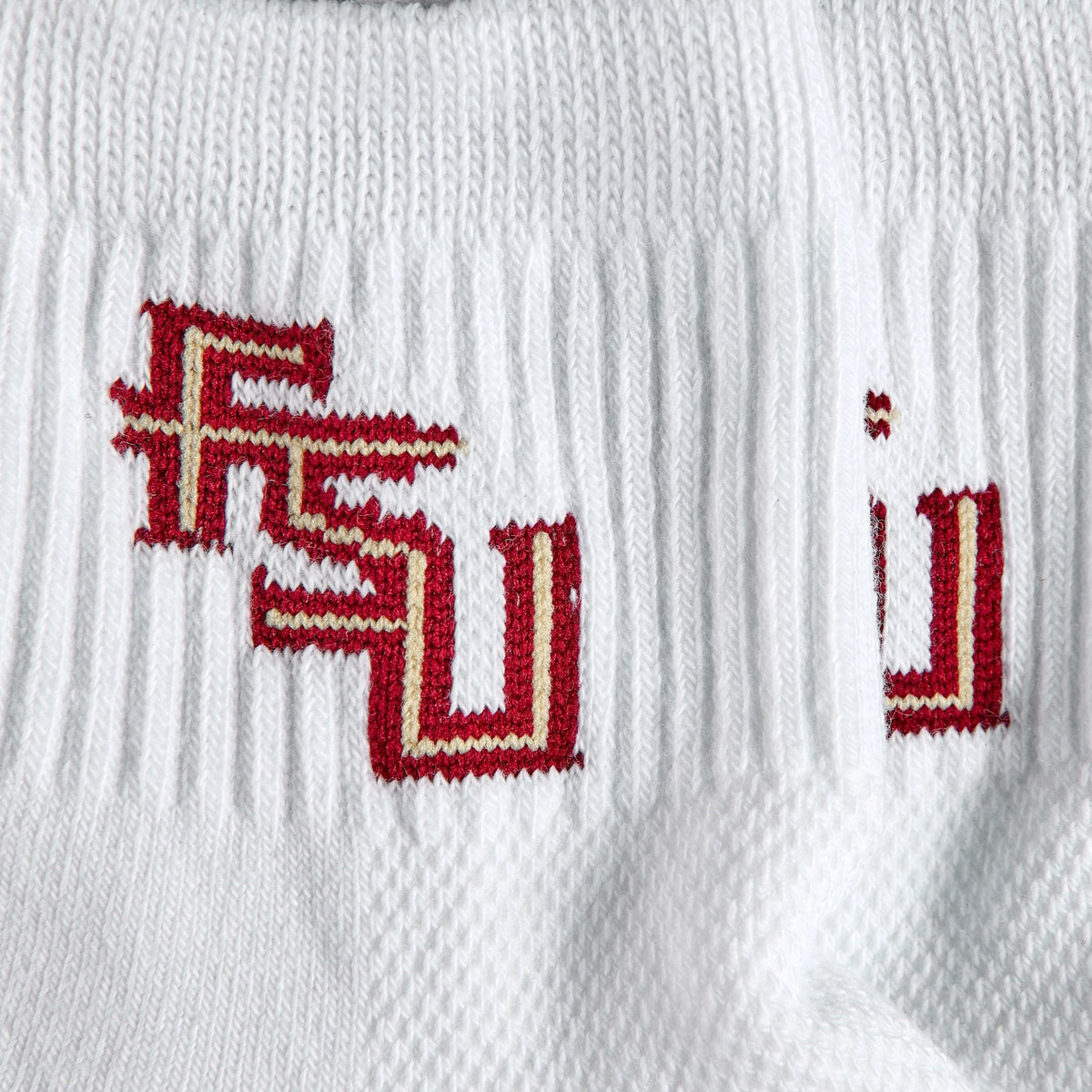 Close-up of the FSU interlock on Del Campo Florida State Script golf socks