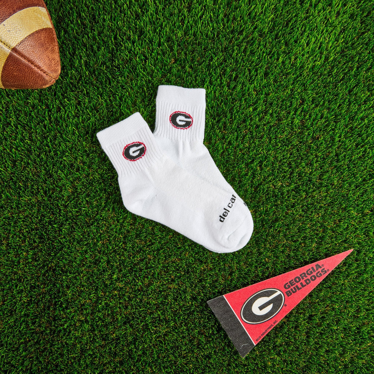 Del Campo Georgia Bulldogs golf socks on turf with a team pennant