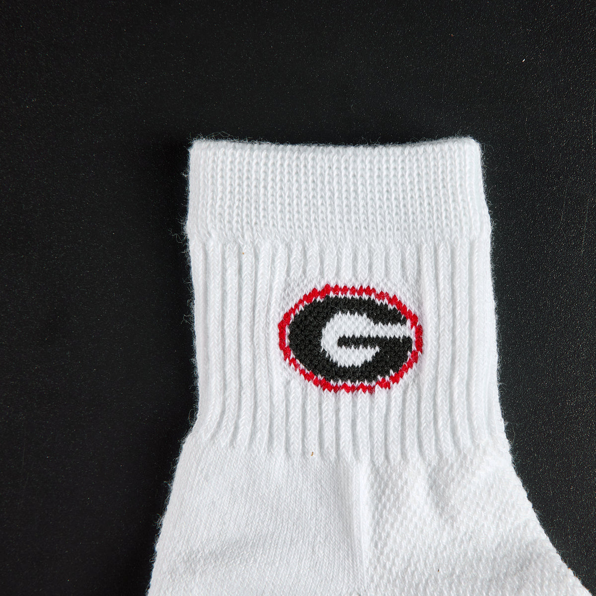 Close-up of the black G in a red oval on Del Campo Georgia Bulldogs golf socks