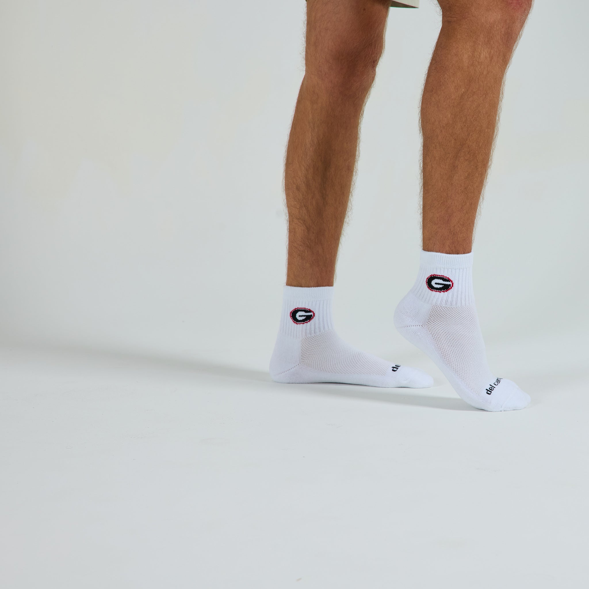 Man wearing Del Campo Georgia Bulldogs golf socks, studio shot, no shoes