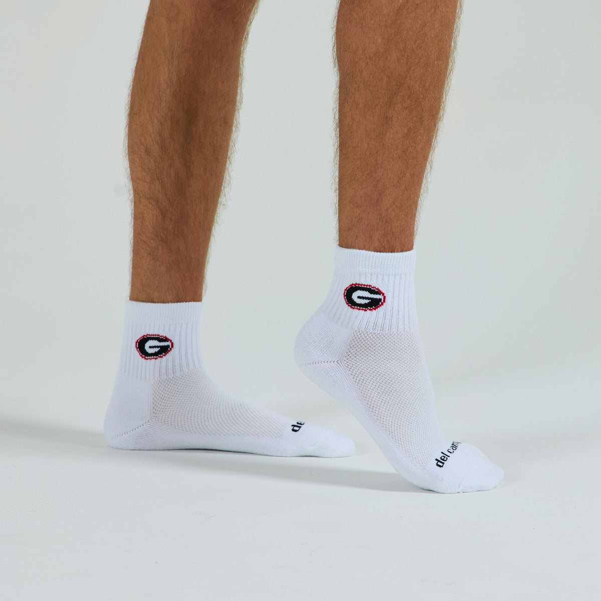 Man wearing Del Campo Georgia Bulldogs golf socks, studio shot, no shoes