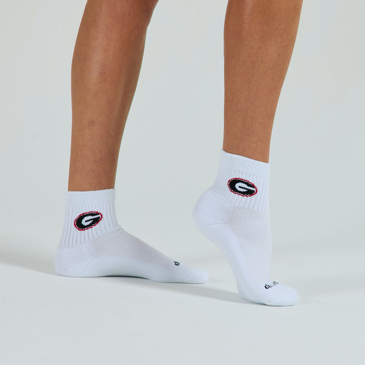 Woman wearing Del Campo Georgia Bulldogs golf socks, studio shot, no shoes