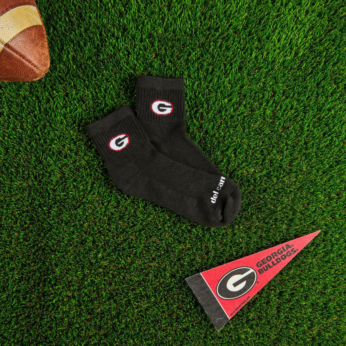 Del Campo Georgia Night Mode golf socks on turf with a team pennant