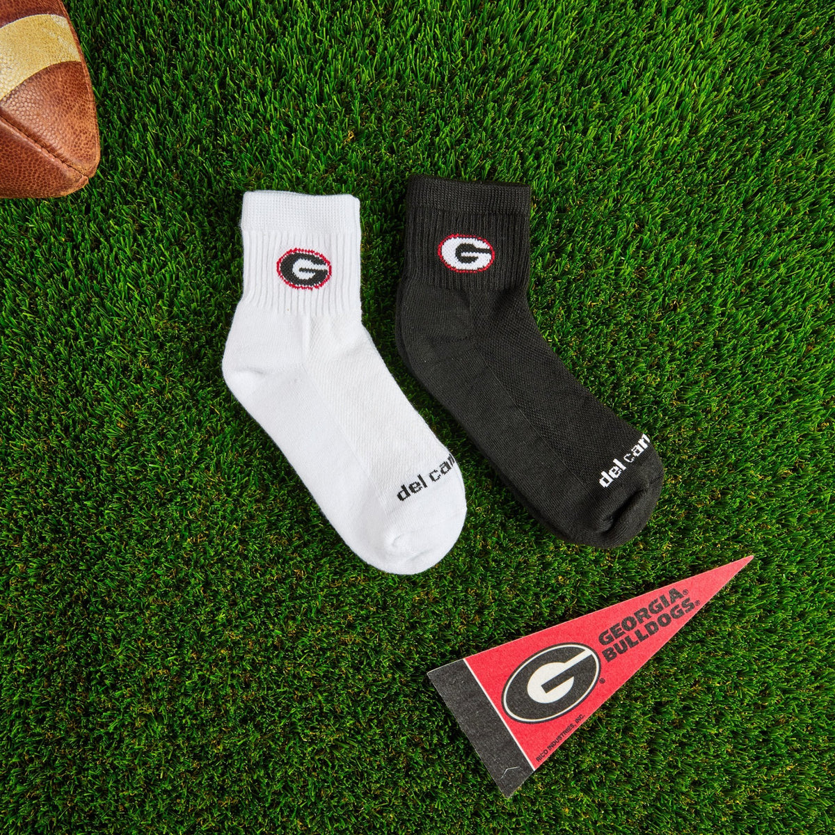 Del Campo Georgia Pack golf socks on turf with a team pennant