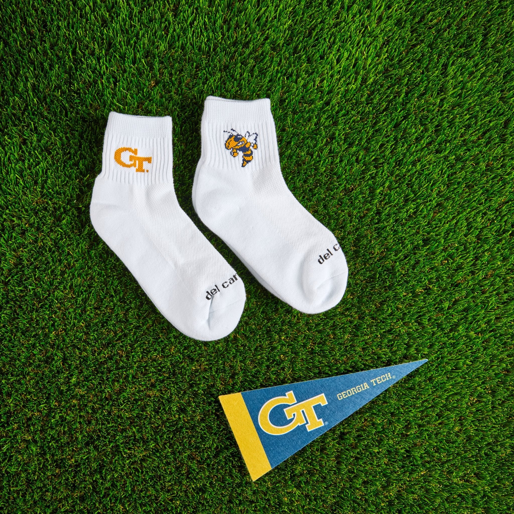 Del Campo Georgia Tech Pack golf socks on turf with a team pennant