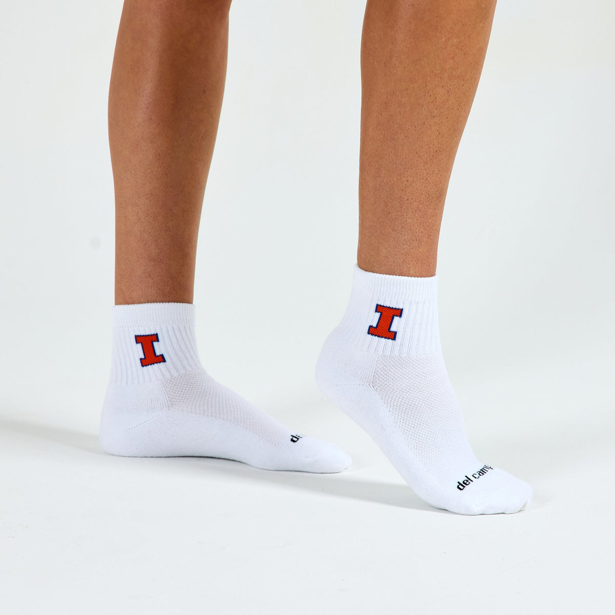Woman wearing Del Campo Illinois Fighting Illini golf socks, studio shot, no shoes