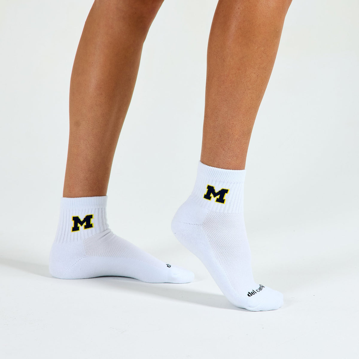 Woman wearing Del Campo Michigan Wolverines Navy golf socks, studio shot