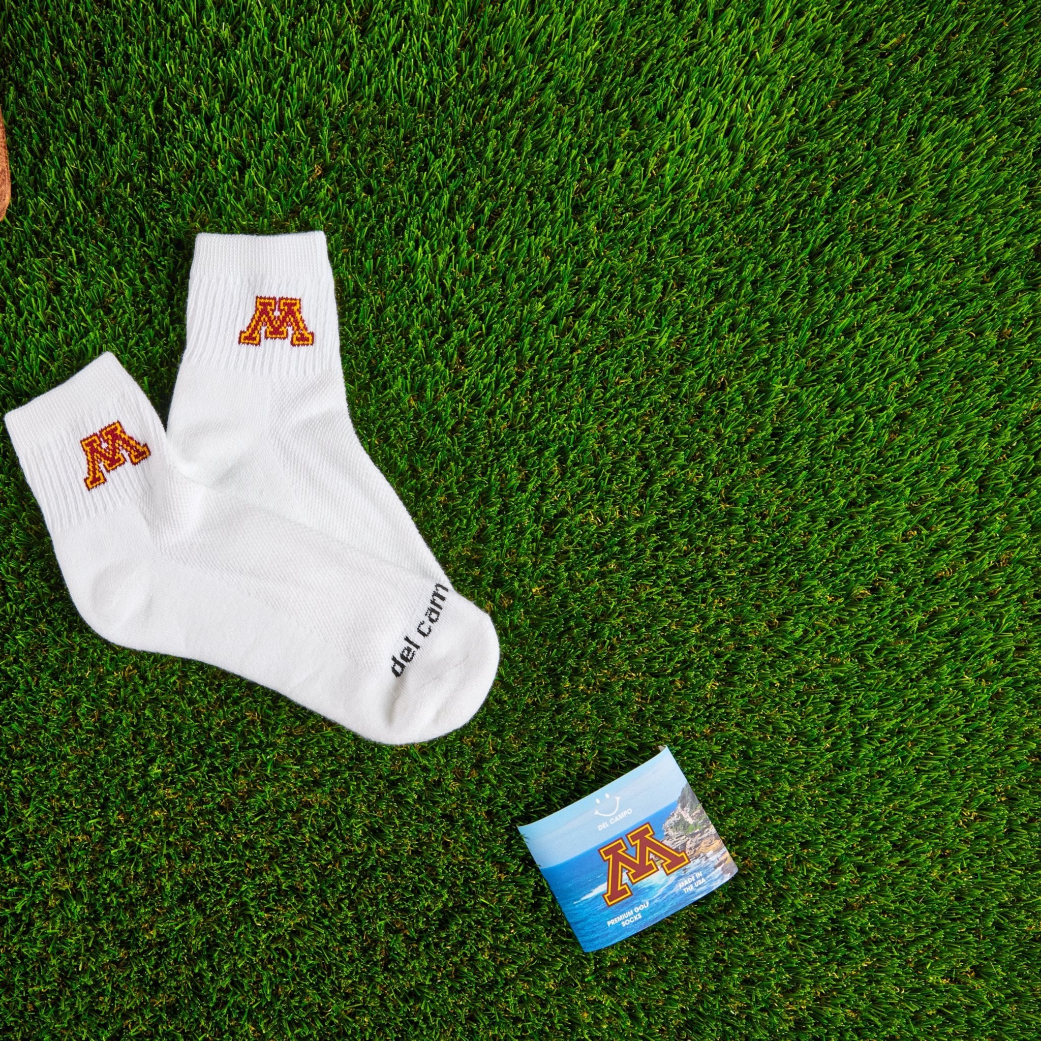 Del Campo Minnesota Golden Gophers golf socks on turf with a team pennant