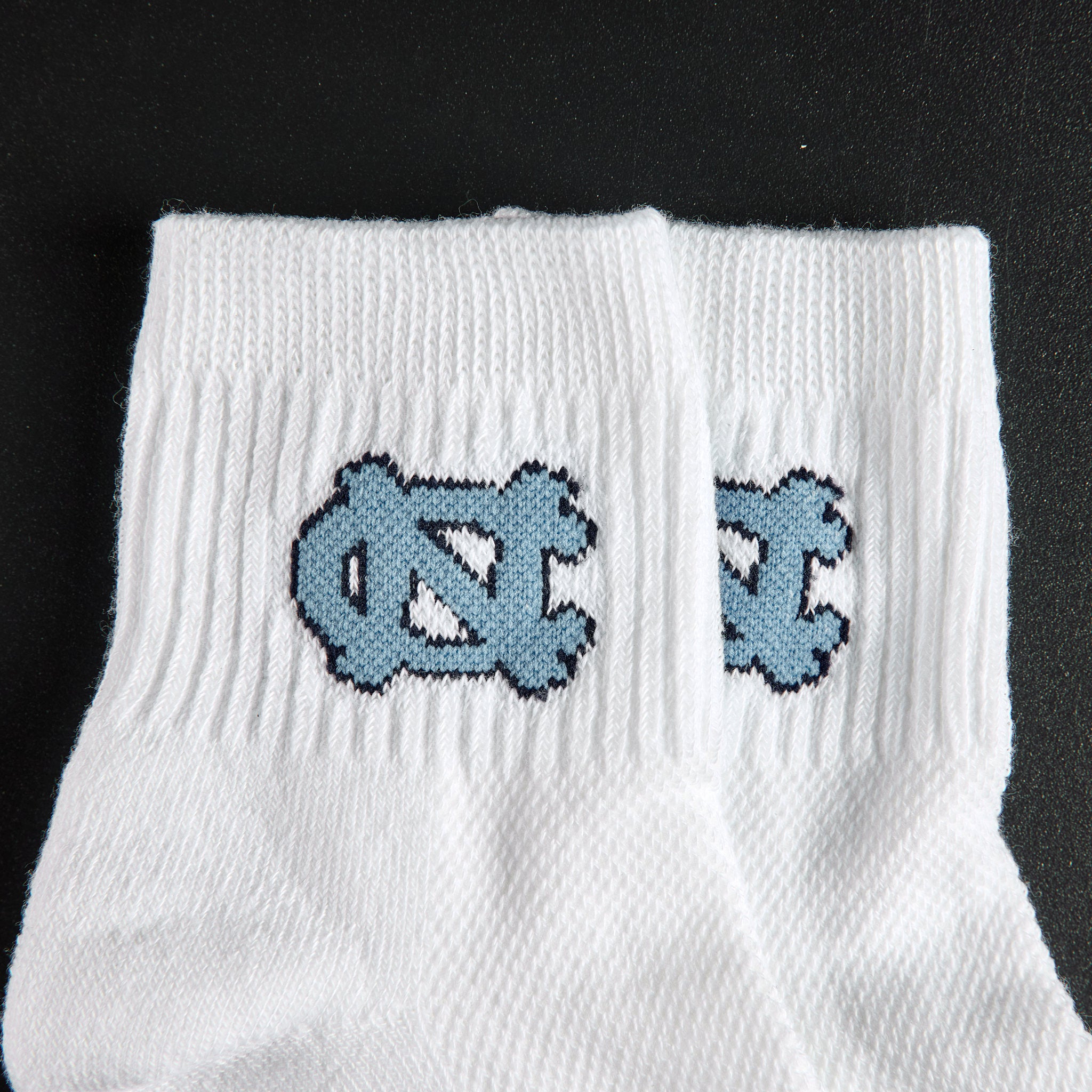 Del Campo North Carolina Interlocking NC golf socks, embroidered Carolina blue NC interlock detail