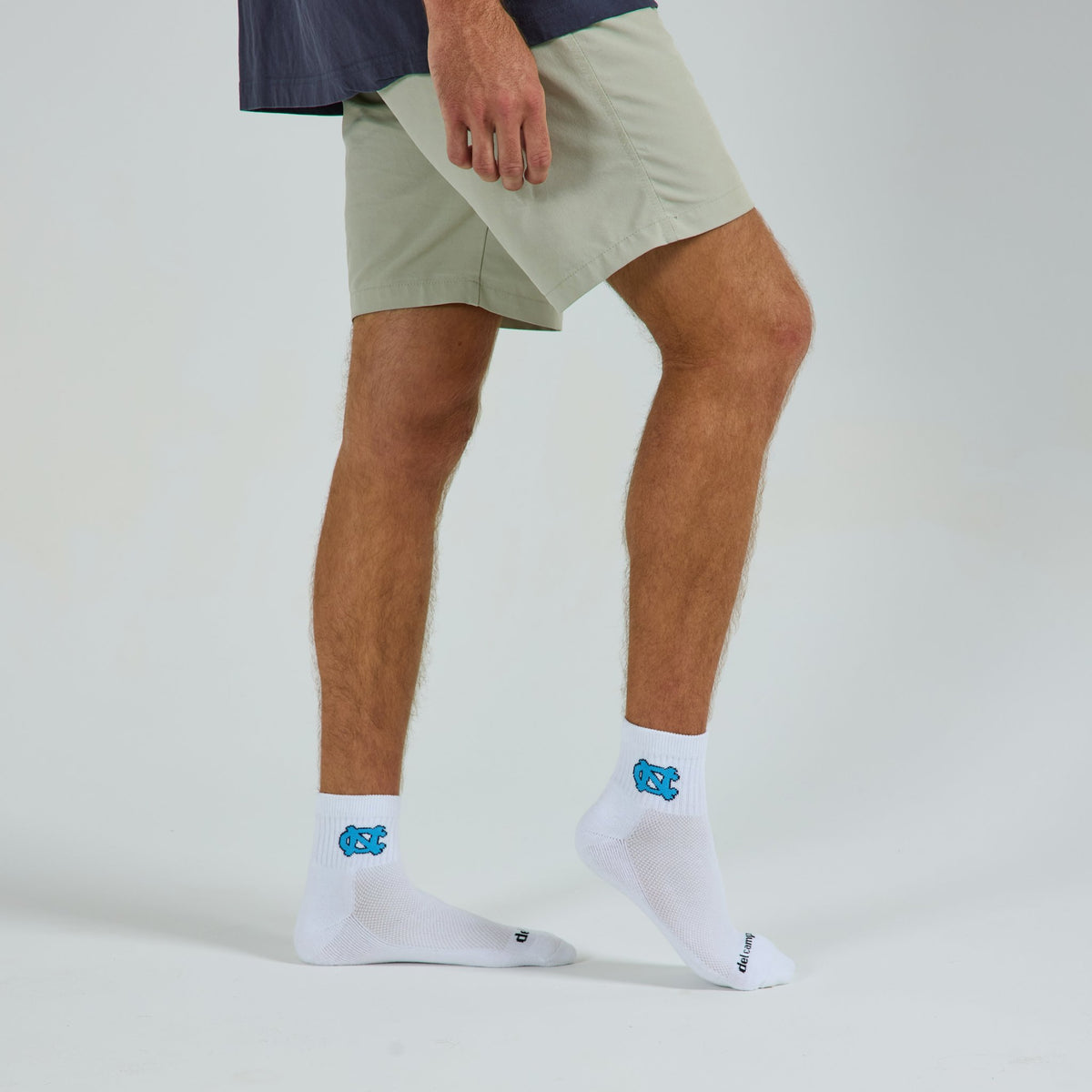 Man wearing Del Campo North Carolina Interlocking NC golf socks, studio shot, no shoes