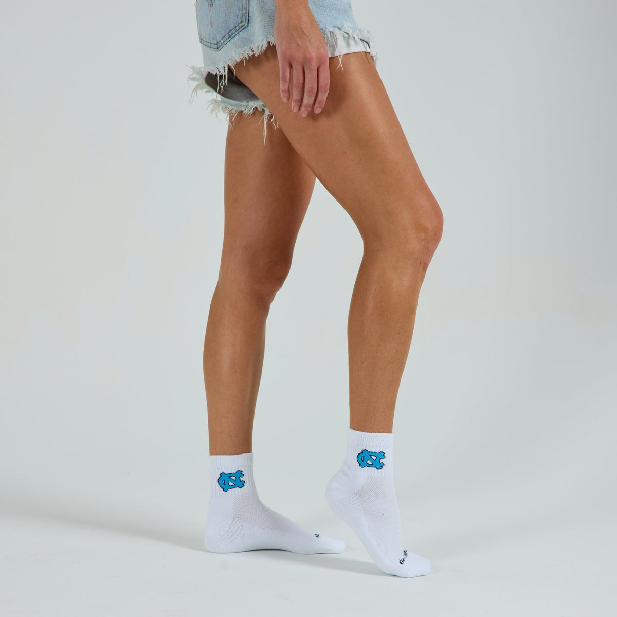Del Campo North Carolina Interlocking NC golf socks on a female model in studio