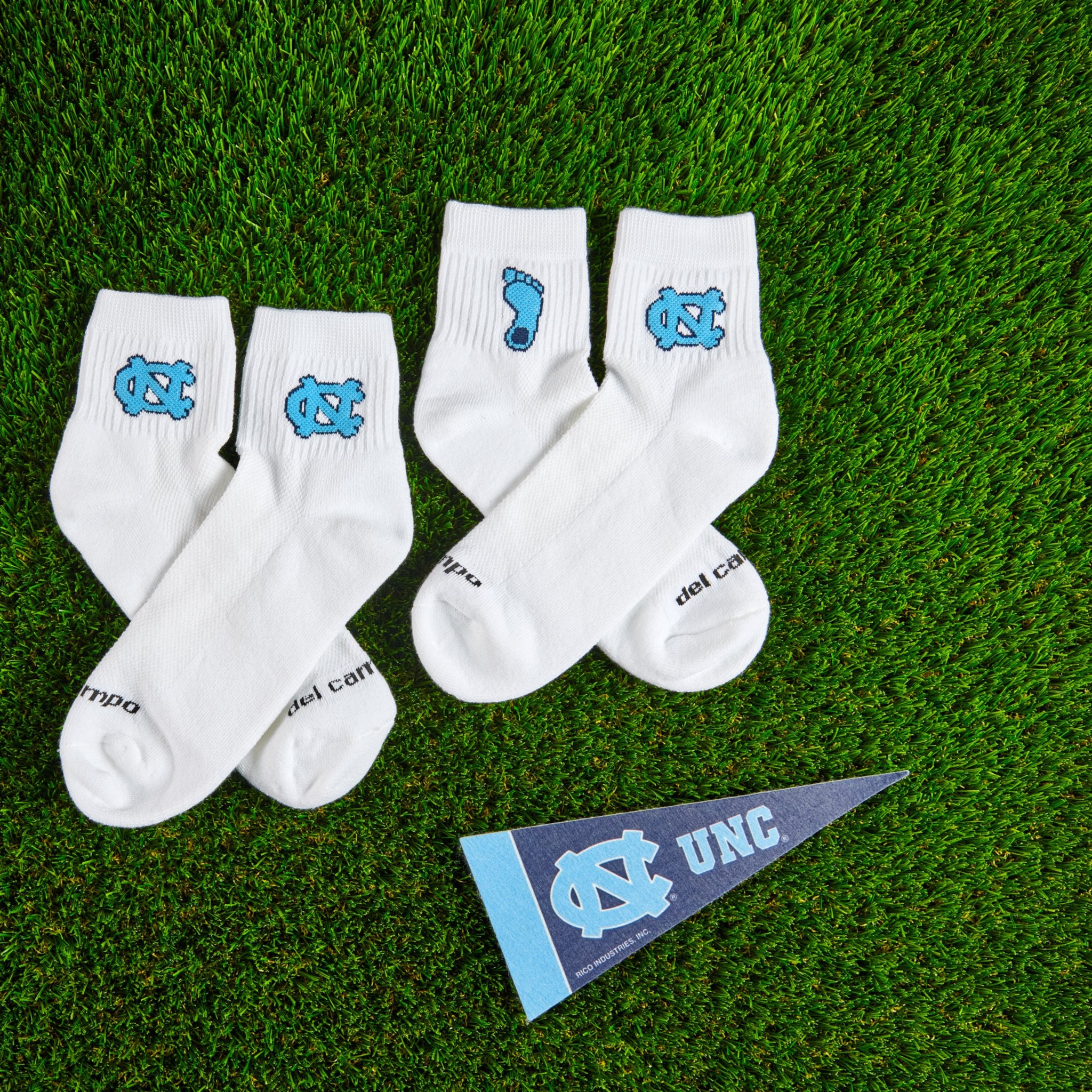 Del Campo North Carolina Pack golf socks on turf with a team pennant