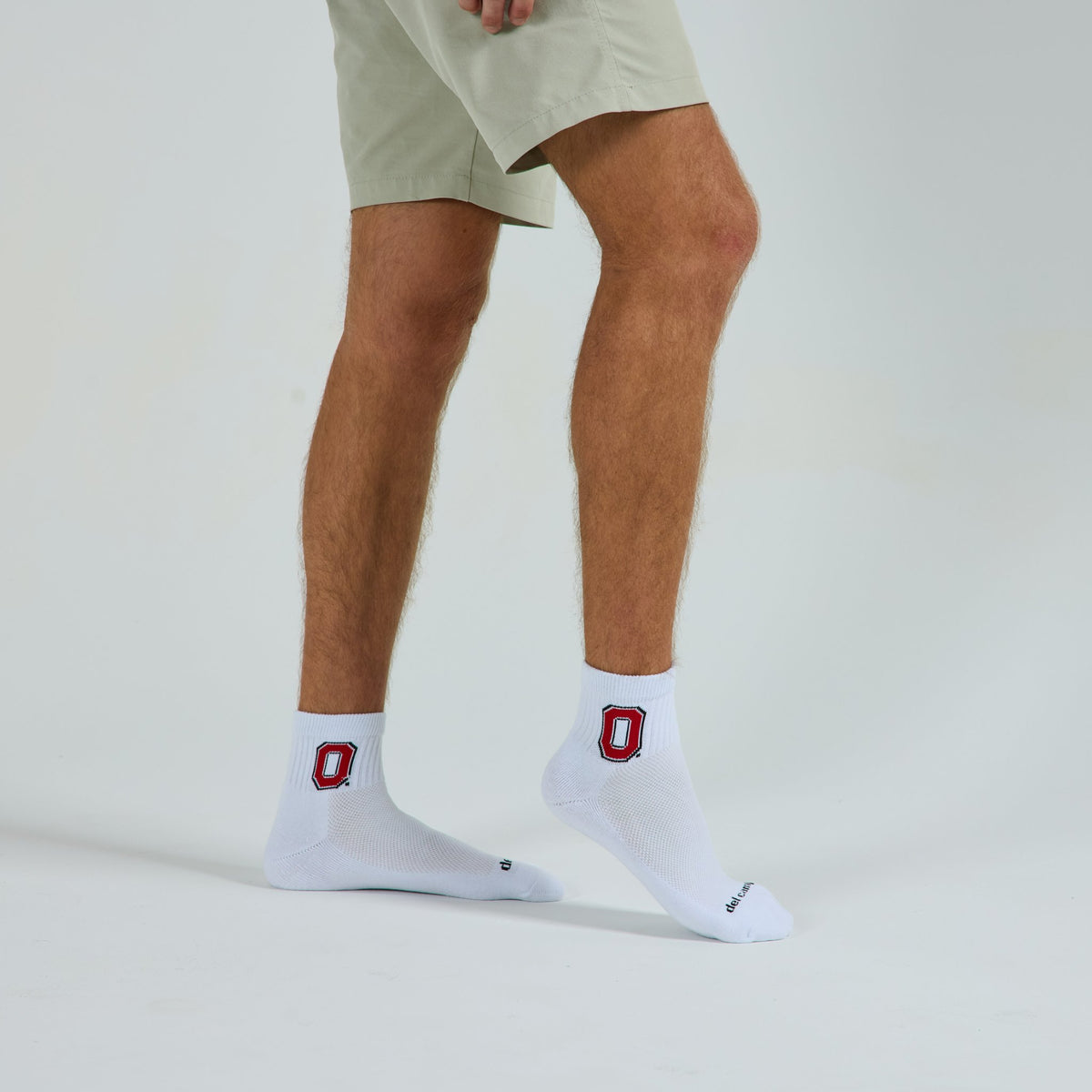 Man wearing Del Campo Ohio State Buckeyes golf socks, studio shot, no shoes