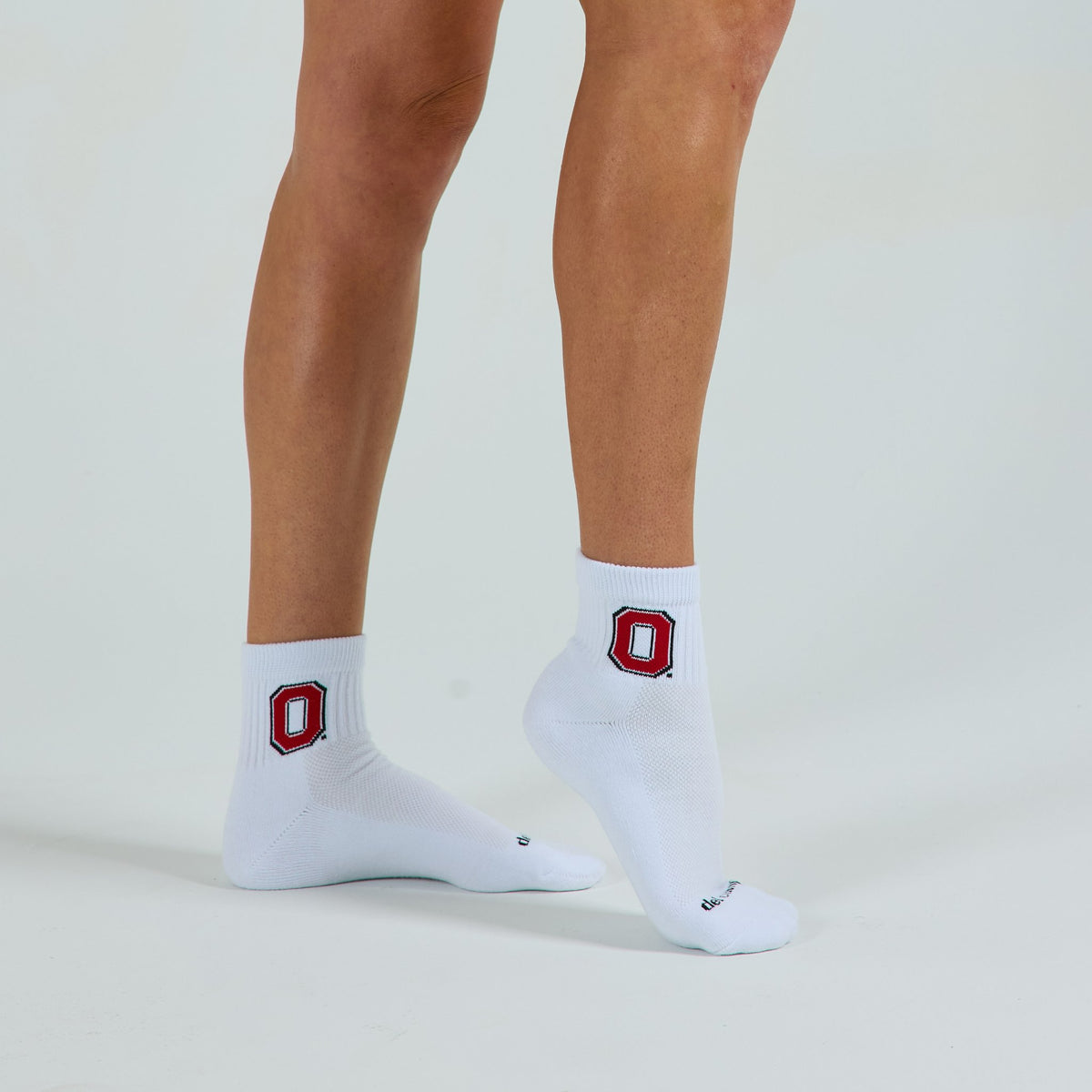 Woman wearing Del Campo Ohio State Buckeyes golf socks, studio shot, no shoes