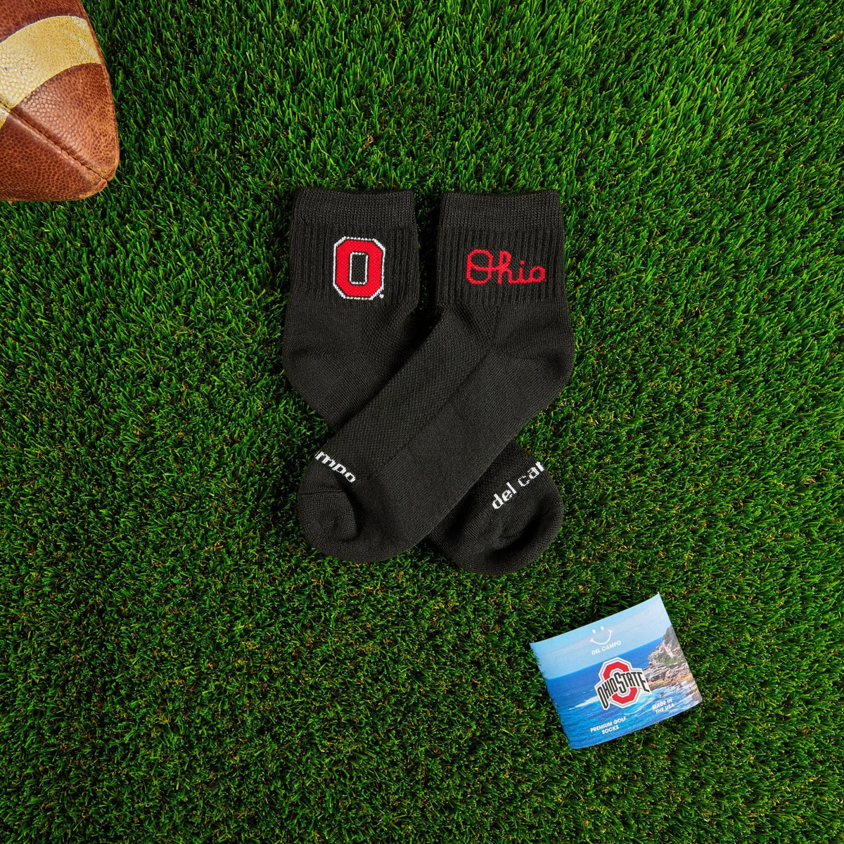 Del Campo Ohio State Night Mode golf socks on turf with a team pennant