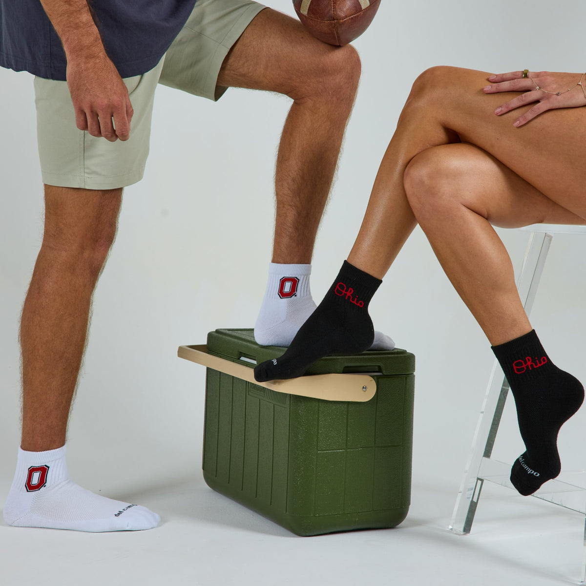 Two models wearing Del Campo Ohio State Pack golf socks in studio
