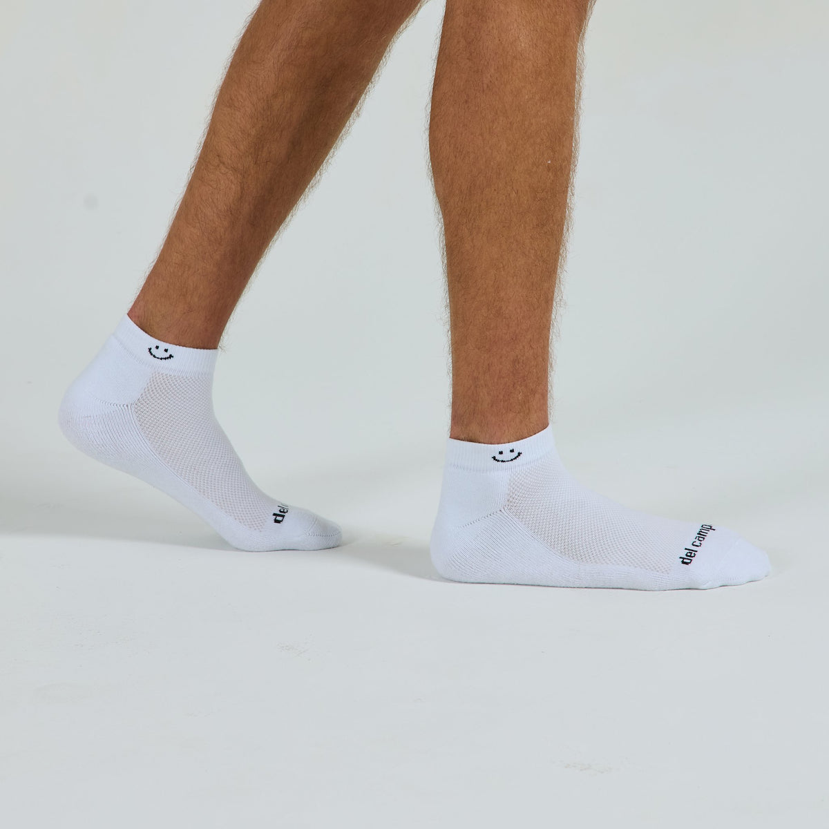 Smiley Lowcut Socks worn barefoot, mid-stride - del campo