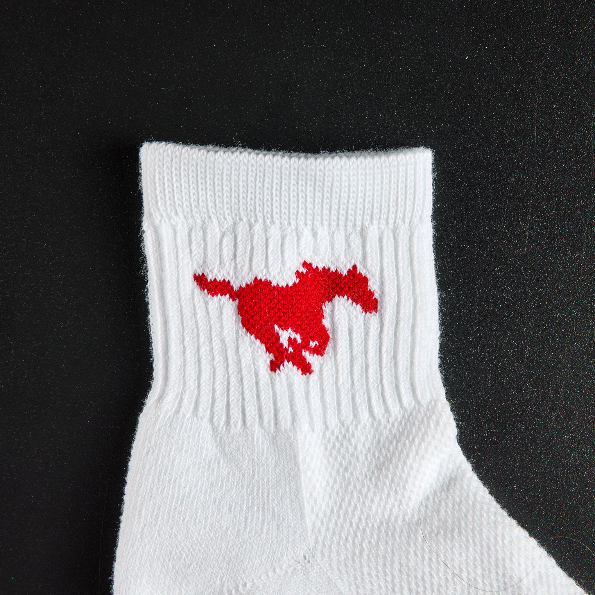 Close-up of the red running Mustang on Del Campo SMU Mustangs golf socks