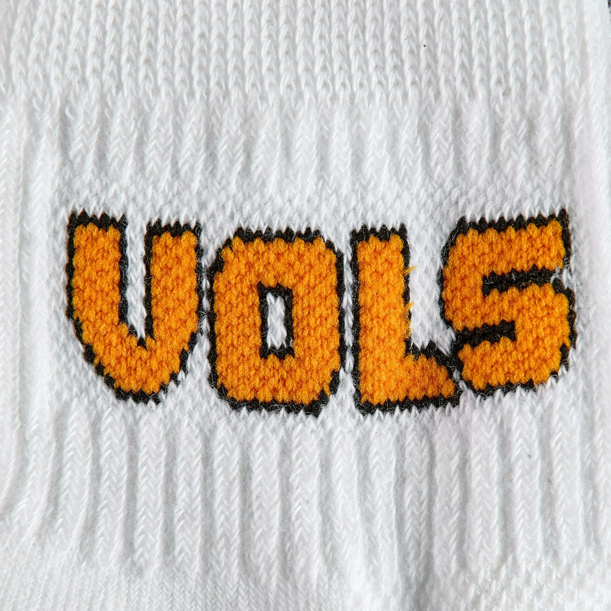 Close-up of the VOLS block wordmark on Del Campo Tennessee Block golf socks