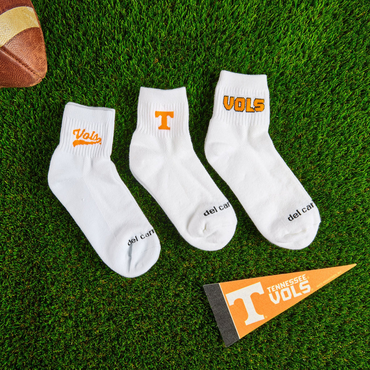 Del Campo Tennessee Pack golf socks styled on turf beside a pennant