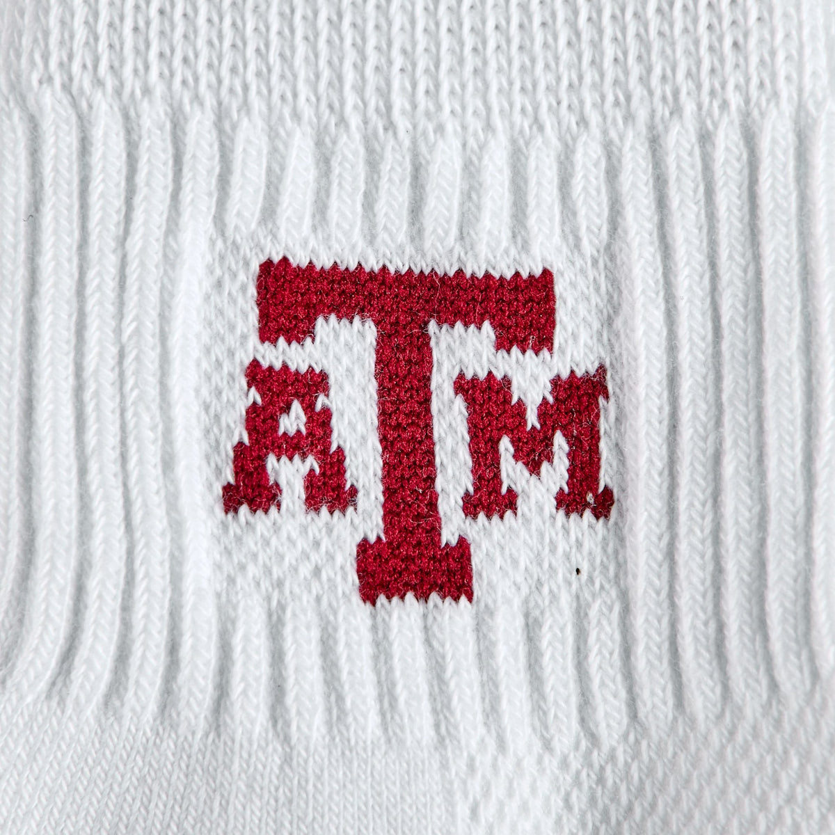 Close-up of the maroon ATM interlock on Del Campo Texas A&M Aggies golf socks