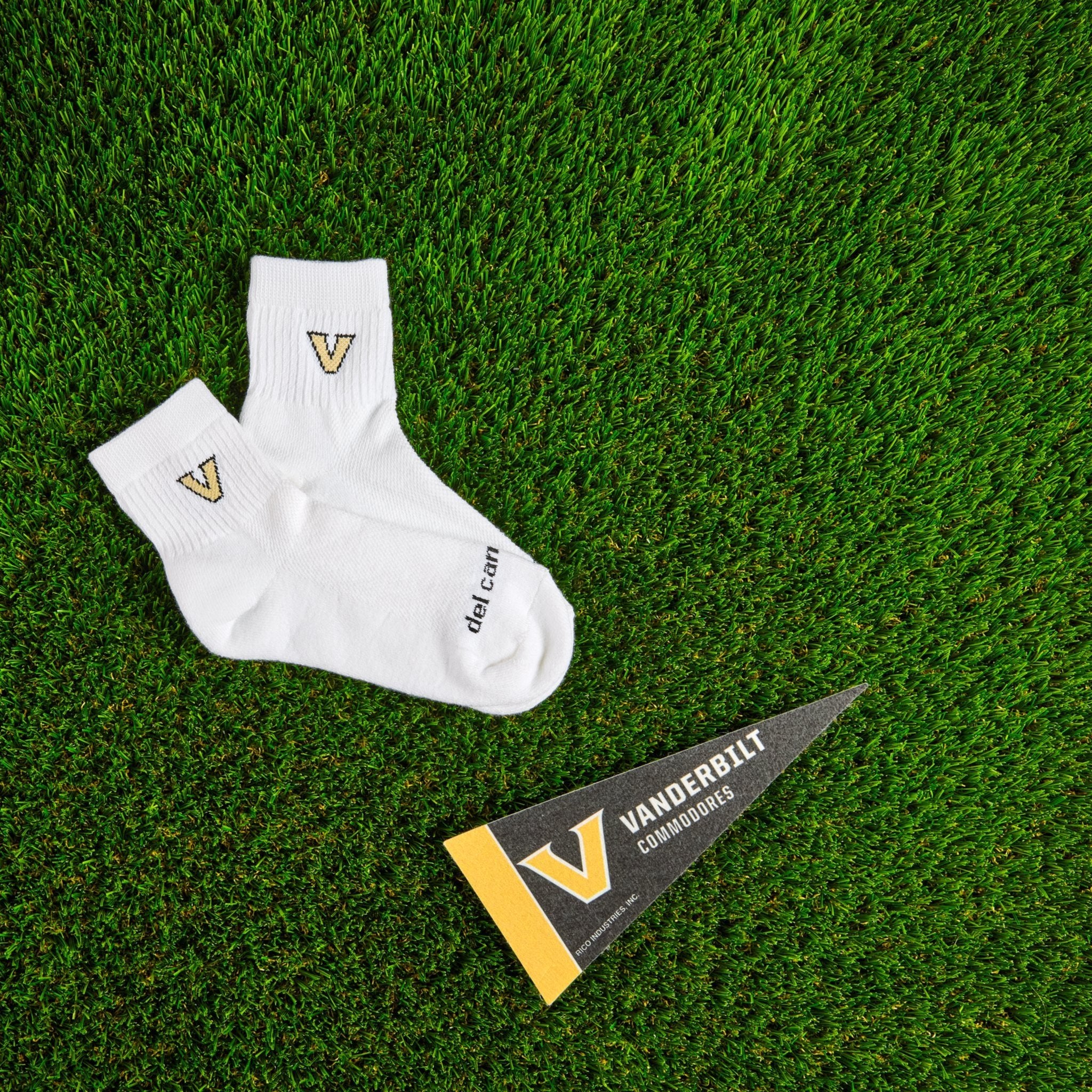 Del Campo Vanderbilt Commodores golf socks on turf with a team pennant