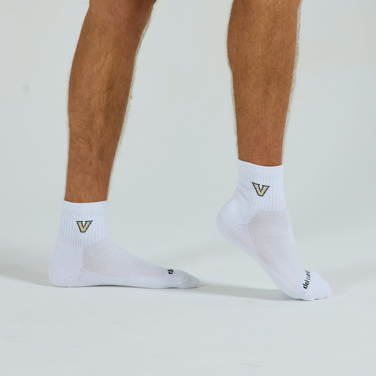 Man wearing Del Campo Vanderbilt Commodores golf socks, studio shot, no shoes