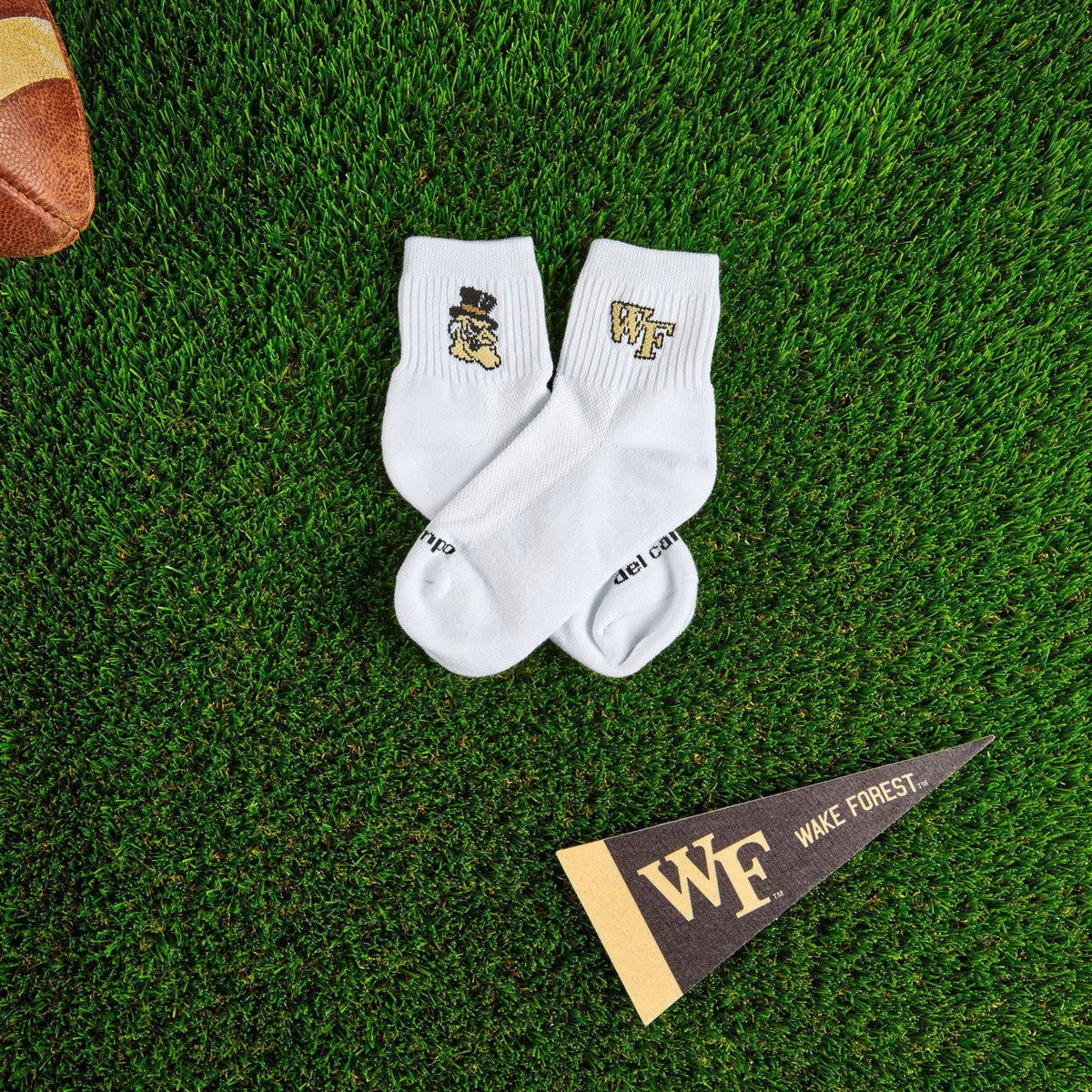 Del Campo Wake Forest Demon Deacons golf socks on turf with a team pennant