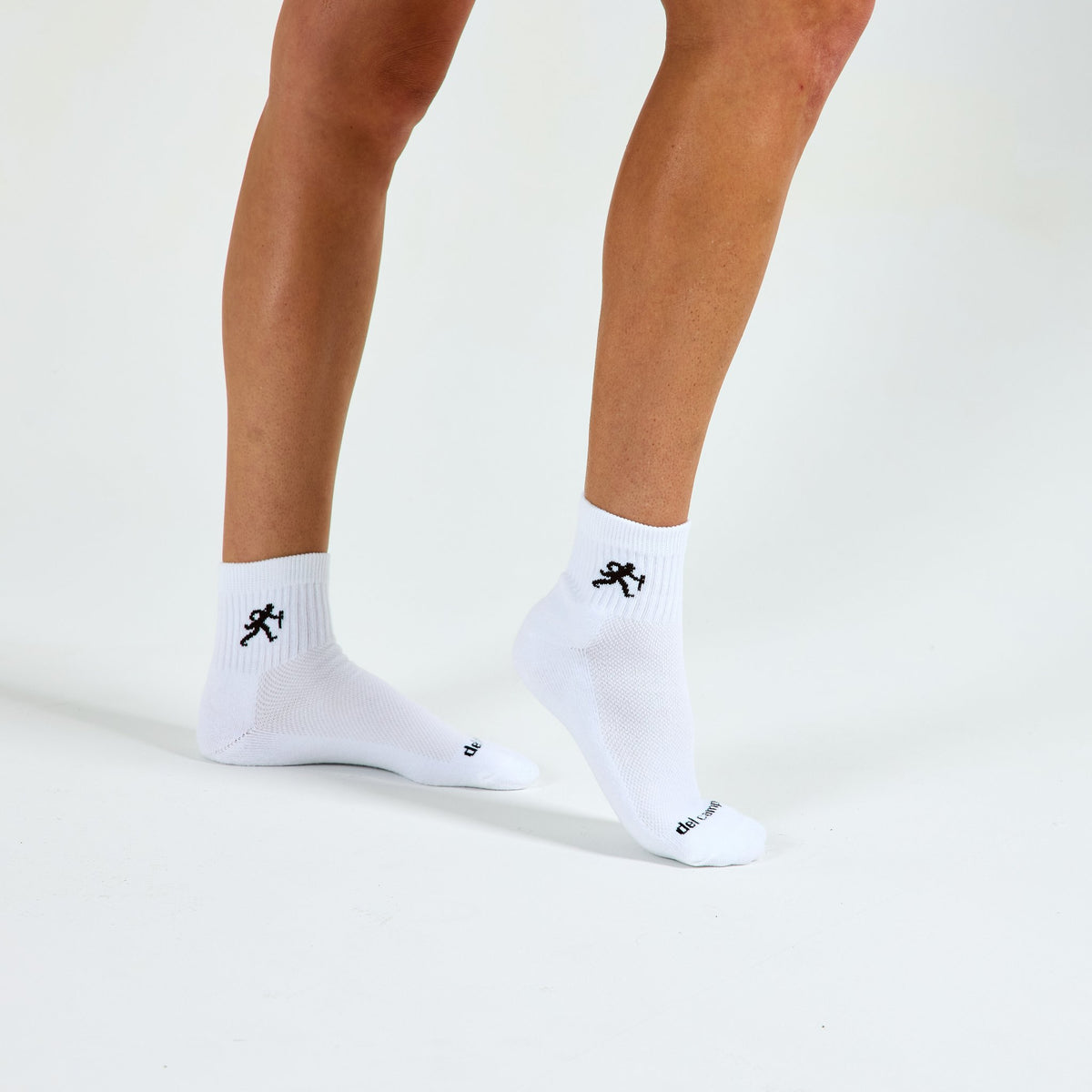 Woman wearing Del Campo Wake Forest Walking Deacon golf socks, studio shot, no shoes