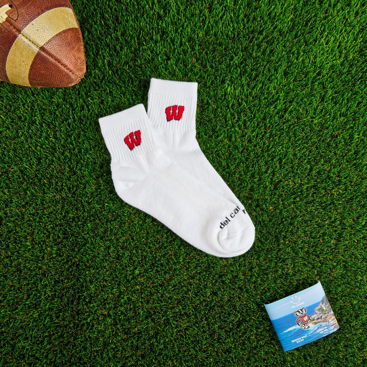 Del Campo Wisconsin Badgers golf socks on turf with a team pennant