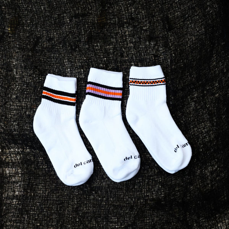 The three Halloween stripe socks on black mesh