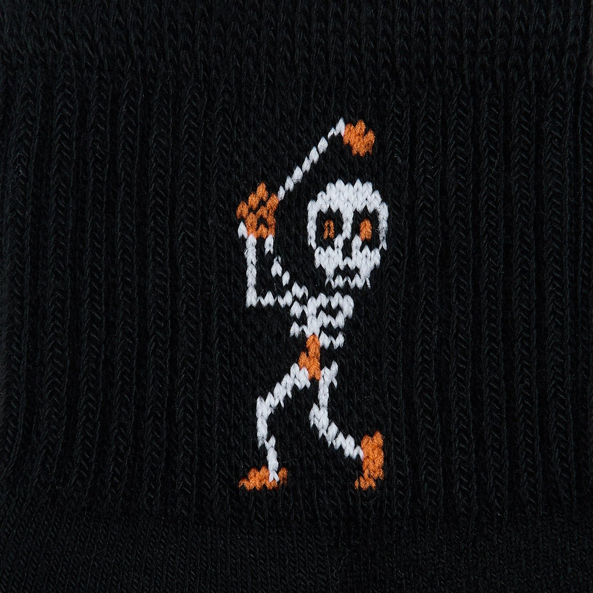 Del Campo Swingin' Skelly Halloween golf socks, black quarter socks with a skeleton golfer mid-swing in white and orange, close-up of the knit skeleton golfer