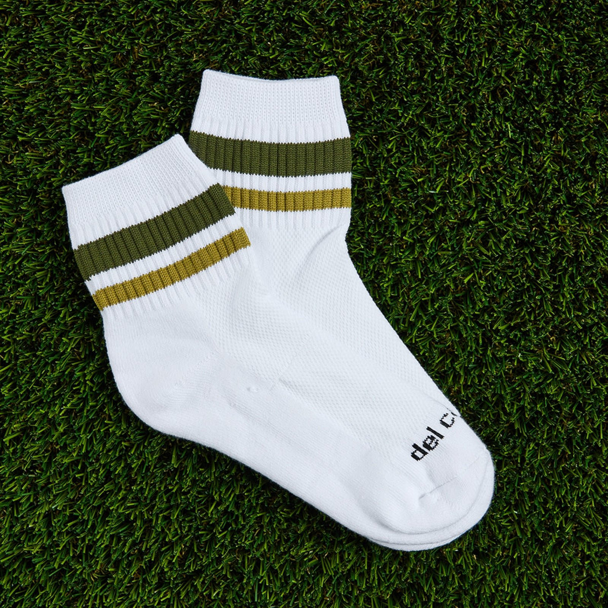 Del Campo Forest Stripes golf socks, flat lay on grass
