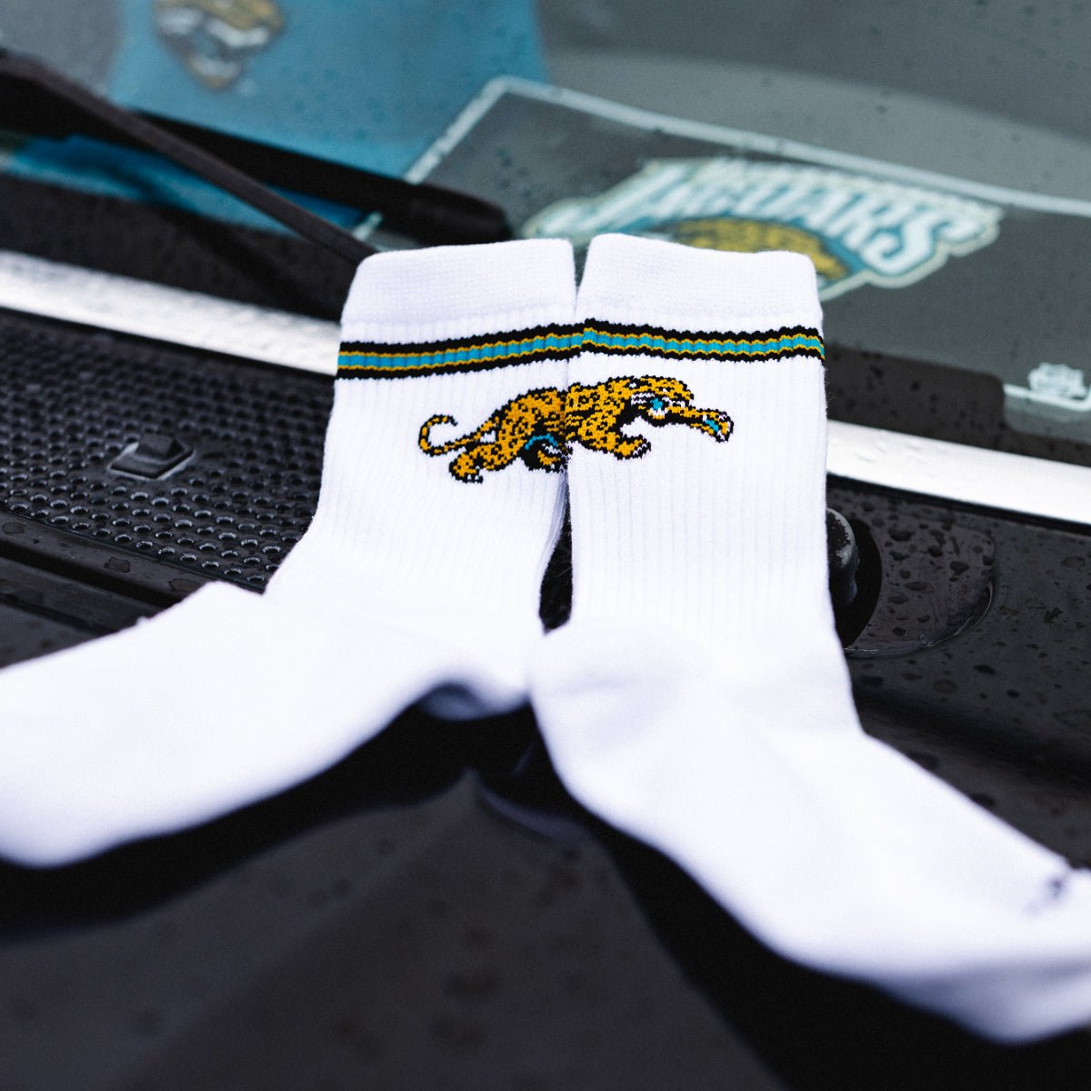 Jacksonville Jaguars crew sock by Del Campo, white with a teal and gold stripe and a prowling jaguar