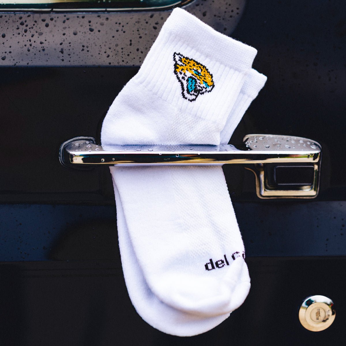 Jacksonville Jaguars quarter sock by Del Campo, white with an embroidered Jaguars head