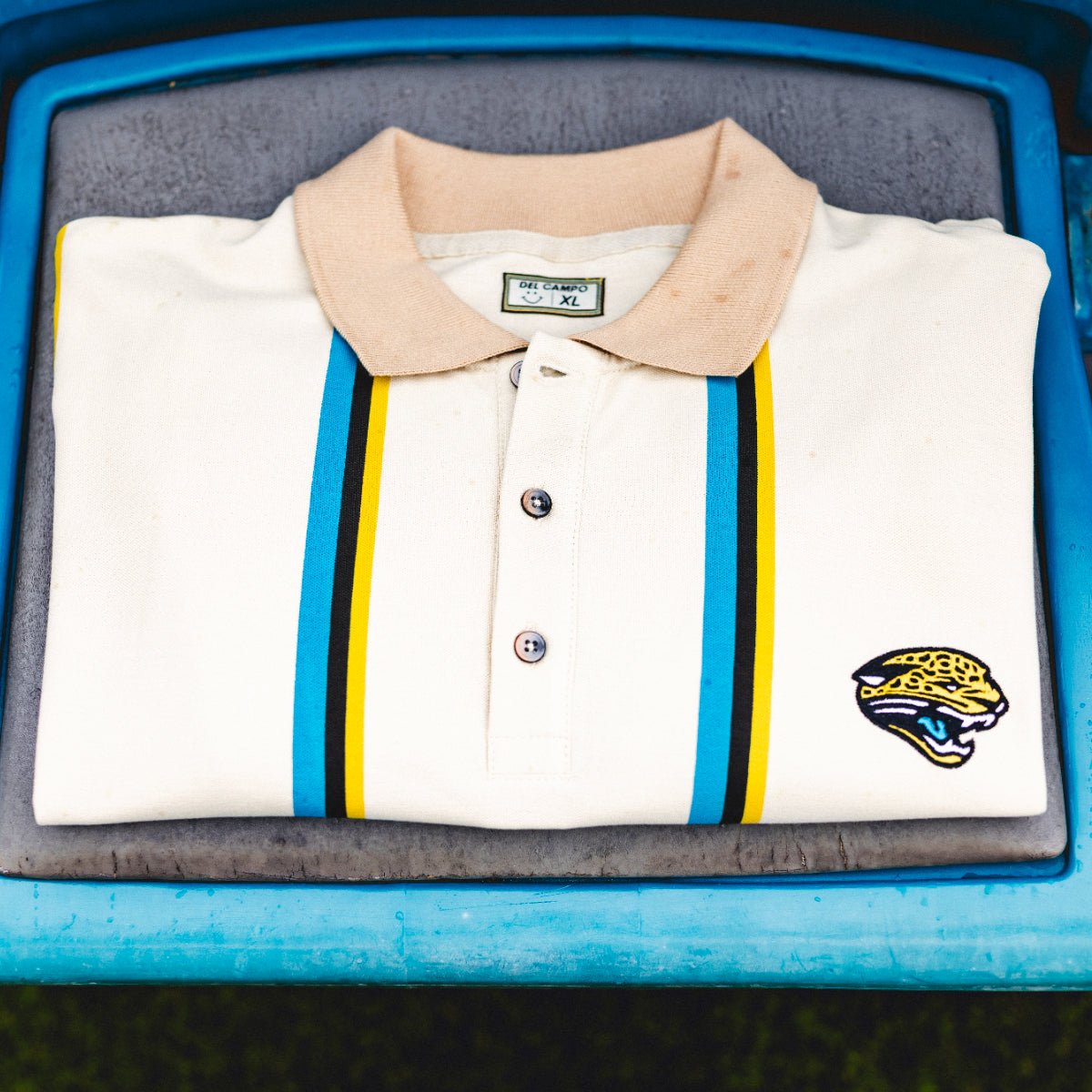 Lot J Polo, officially licensed Jacksonville Jaguars cream polo with teal and gold stripes by Del Campo